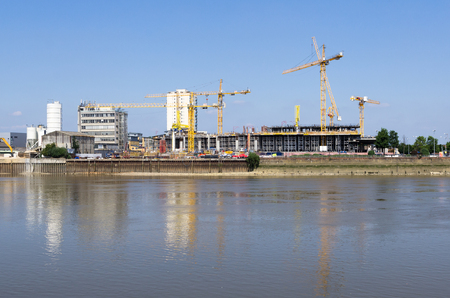 cranes working on a construction site on thamesの写真素材