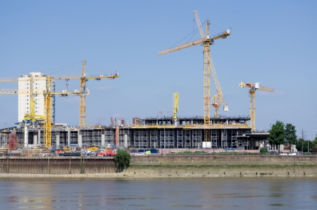 cranes working on a construction site on thamesの写真素材