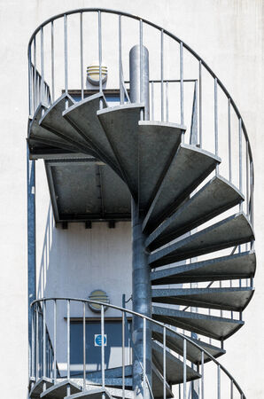 metal spiral staircase outside the buildingの写真素材