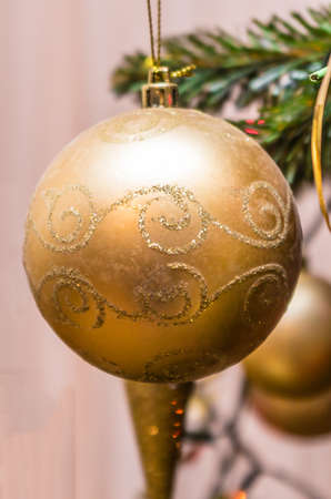 Golden bauble on the Christmas treeの写真素材