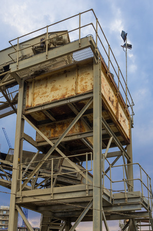 construction industry with a mechanical conveyor belt emptying the processed crushed rock onto a pile or dumpの写真素材