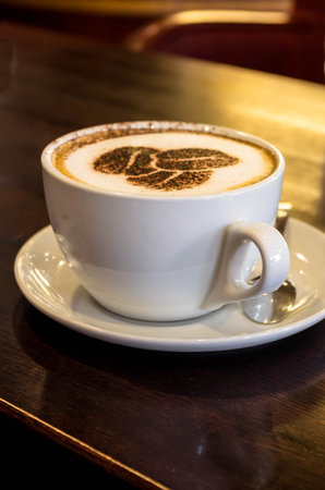 White cup of aromatic coffee, very nicely decorated chocolateの写真素材