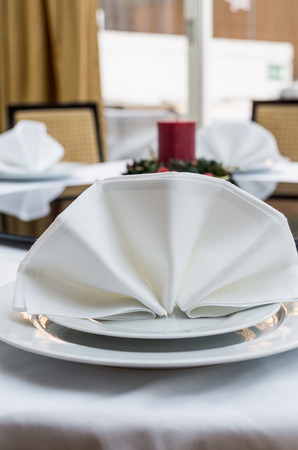 Empty served restaurant table with white tableclothの写真素材