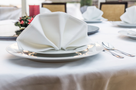 Empty served restaurant table with white tableclothの写真素材