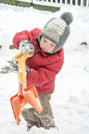 SMall boy playing with snow. winter seasonの写真素材