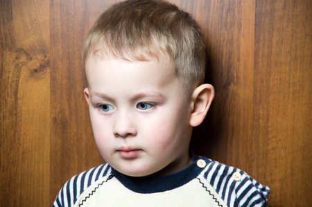 a sad  young caucasian boy. looking awayの写真素材