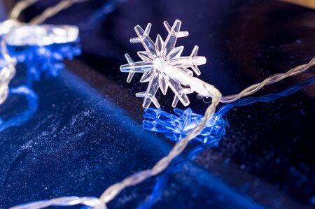 A glowing white xmass star at blue reflective backgroundの写真素材