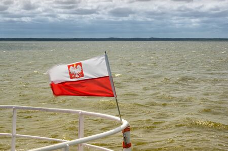 A polish flag at front of ship.の写真素材