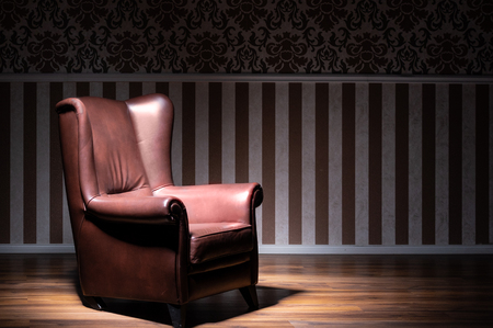 big brown armchair  in spotlight, britishstyle wallpapaerの写真素材