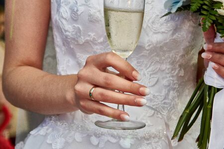 a bride holding glass of campagneの写真素材
