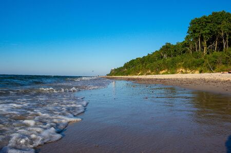 Wiselka,westpomeraia, Poland - July 21 2018 - Bach during sunset, people waliking and playingの写真素材