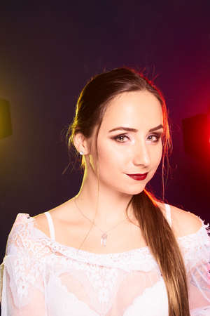 Portrait of caucasian beautful woman, Studio shoot with color backlightの写真素材