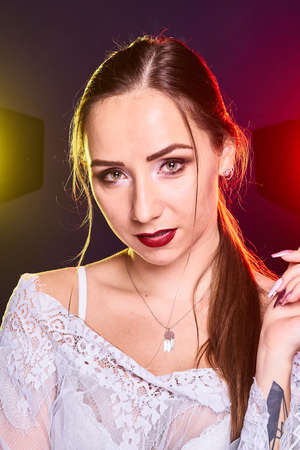 Portrait of caucasian beautful woman, Studio shoot with color backlightの写真素材