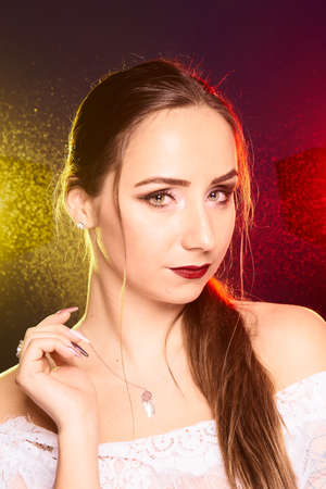 Portrait of caucasian beautful woman, Studio shoot with color backlightの写真素材