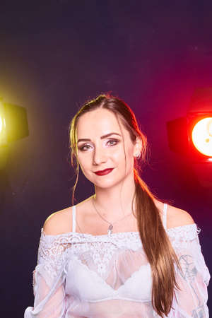 Portrait of caucasian beautful woman, Studio shoot with color backlightの写真素材