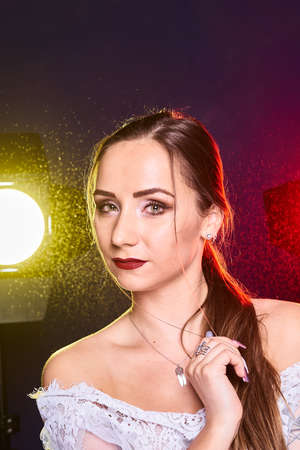 Portrait of caucasian beautful woman, Studio shoot with color backlightの写真素材