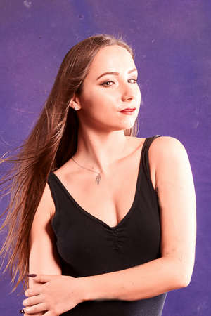 A caucasian girl, dancer, weread black body. violet baclgroundの写真素材