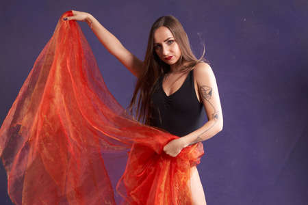 a white nice and fit girl, dancing with Orange sash.の写真素材