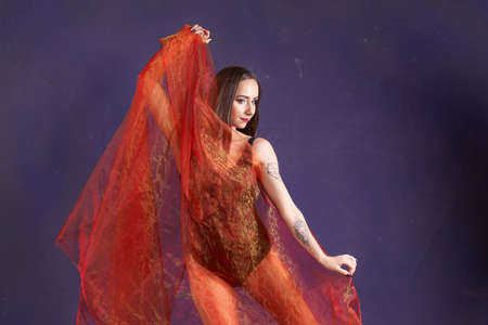 a white nice and fit girl, dancing with Orange sash.