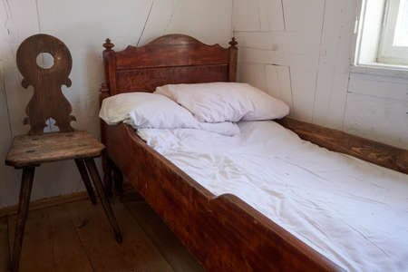 OLd chamber with old wooden bed.の写真素材