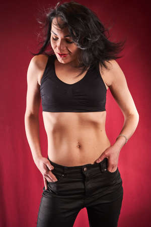 young beautifyl brunette posing, red backgrounの写真素材