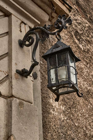 A very old, iron, medieval lampの写真素材