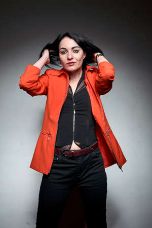 A young brunette wearing an orange suit,の写真素材