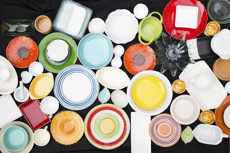 Colorful dishes and utensils on a black backgroundの写真素材