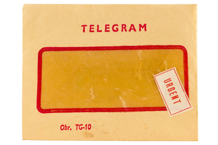 Old telegram envelope with urgent mark isolated on whiteの写真素材