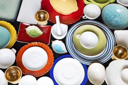 Colorful dishes and utensils on a black backgroundの写真素材