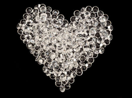 Heart made by glass beads on a black backgroundの写真素材
