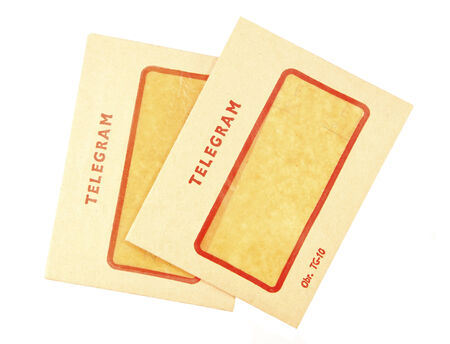 Two old telegram envelopes on white