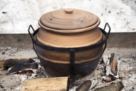 Clay pot on fireの写真素材