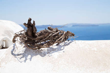 Wreath made with dry branches on the white wallの写真素材