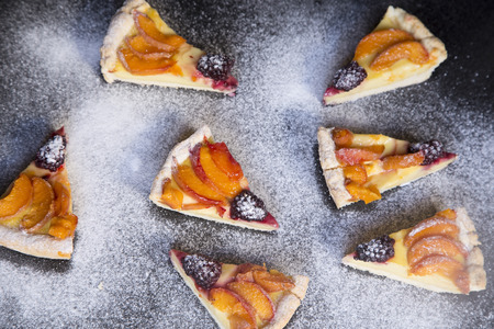 Fruit tarts on the powder sugar backgroundの写真素材