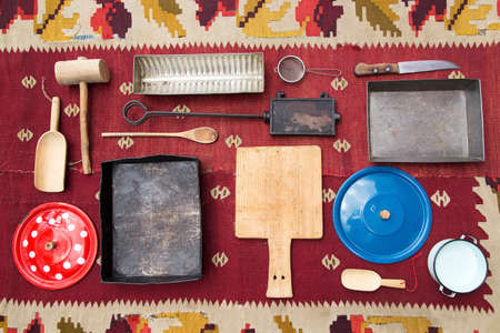 Vintage kitchen utensills on an old shabby carpetの写真素材