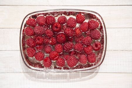 Raspberries in a glass bowlの写真素材