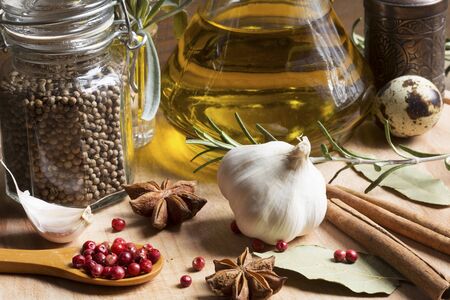 Spices and olive oil on a wooden backgroundの写真素材