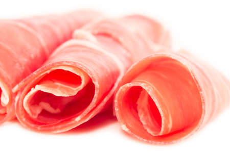 Prosciutto slices isolated on whiteの写真素材