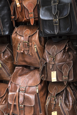 Leather back packs on a marketの写真素材