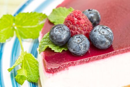 Cheesecake with the fresh raspberries and blueberriesの写真素材