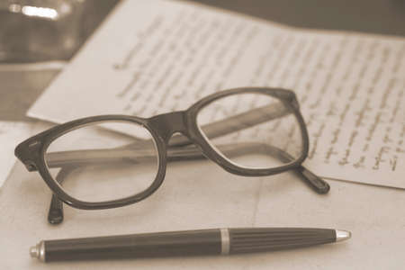 Vintage glasses and pen - toned imageの写真素材