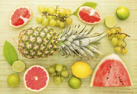 Fresh fruits on a gray straw backgroundの写真素材