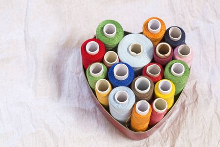 Colorful threads on a white paper