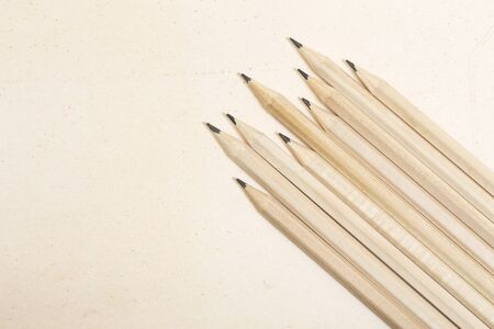 Wooden pencils on a paper backgroundの写真素材