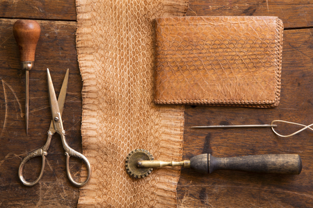 Leather craft tools on a wooden backgroundの写真素材