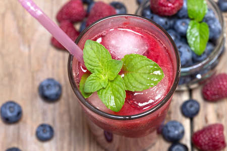 Raspberry juice with the fresh raspberries and blueberriesの写真素材