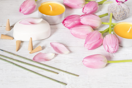 Candles,tulips, soap and incense sticks on white backgroundの写真素材
