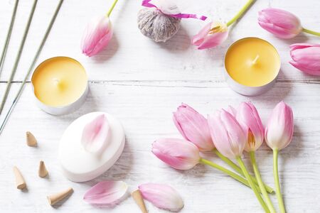 Candles,tulips, soap and incense sticks on white backgroundの写真素材