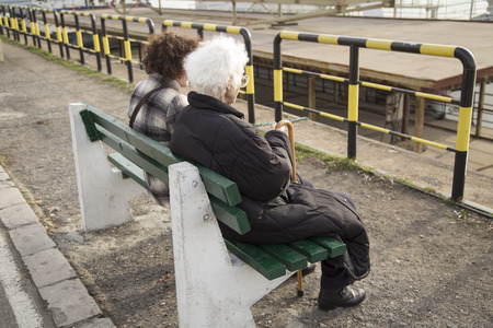 Older woman sitting on a benchの写真素材